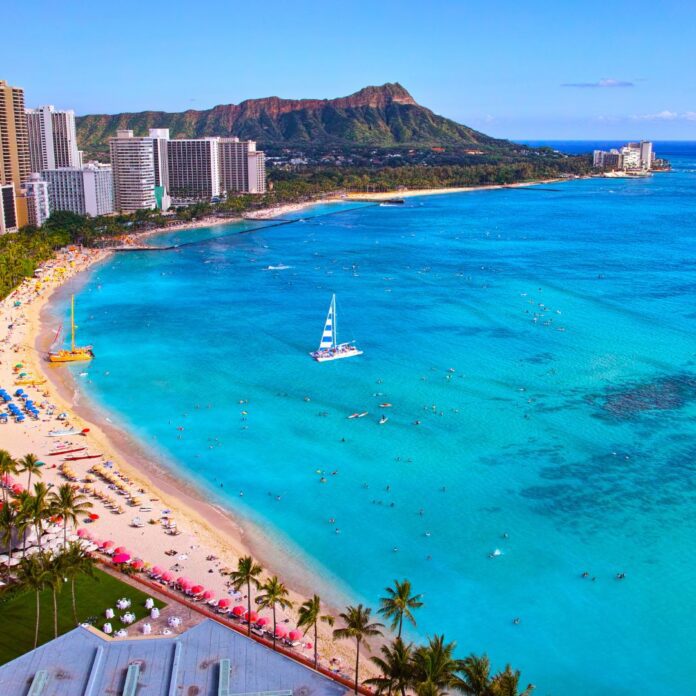 a beach with a sailboat in the water