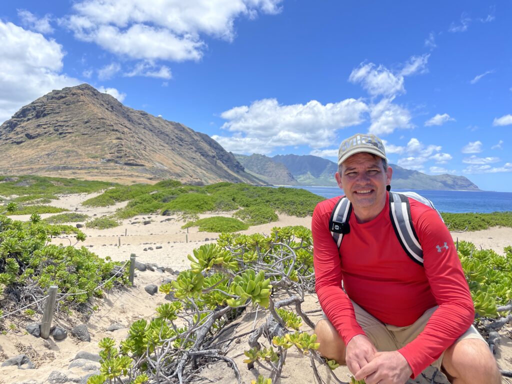 Ka'ena Point Hike: An Unforgettable Experience in Hawaii Hawaii Calling a man sitting on a beach