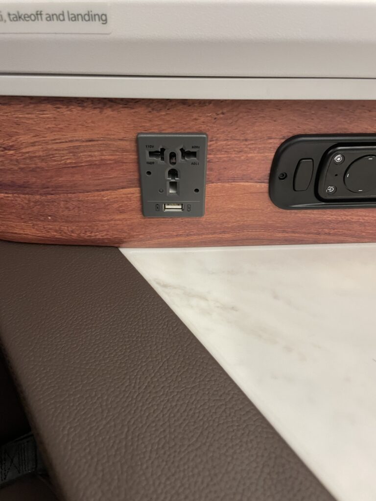 A Sneak Peek Of Hawaiian Airlines Boeing 787 Dreamliner Business Class Seats Hawaii Calling a close up of a power outlet