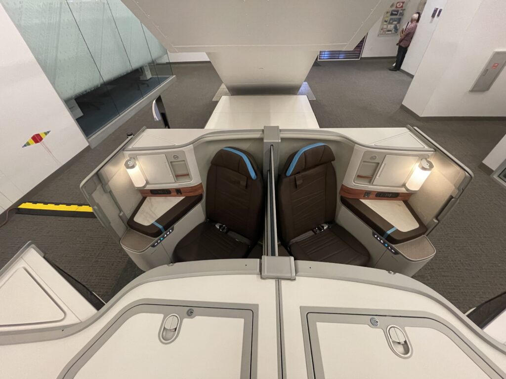 A Sneak Peek Of Hawaiian Airlines Boeing 787 Dreamliner Business Class Seats Hawaii Calling a room with seats and a window