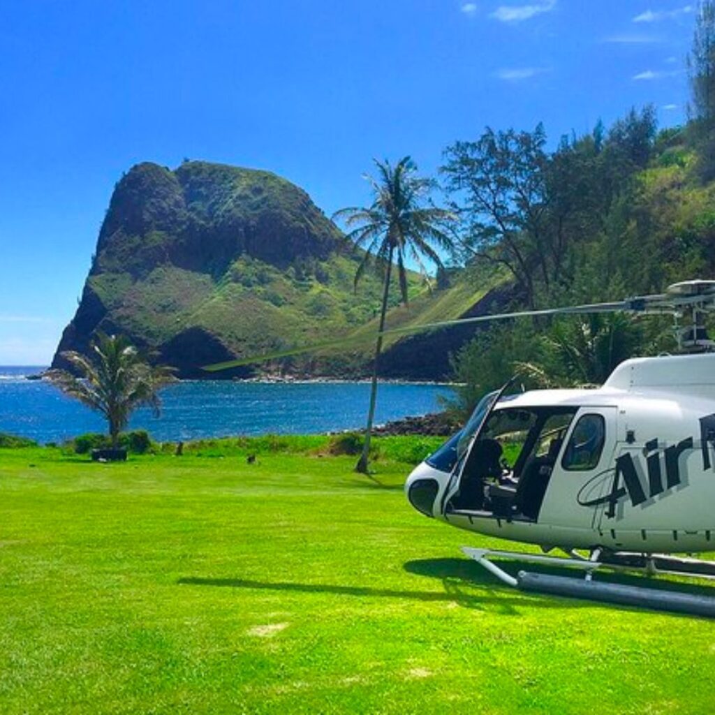 The 26 Best Things To Do On Maui | Bucket List Guide (2025) Hawaii Calling a helicopter parked on grass next to a body of water
