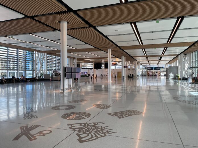 a large airport with white columns and a large ceiling