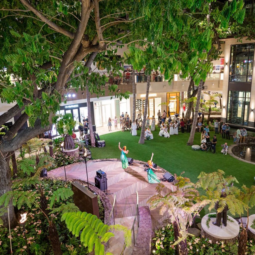 The 23 Best Things To Do In Waikiki |A Local Guide (2025) Hawaii Calling a group of people in a courtyard with trees and people around