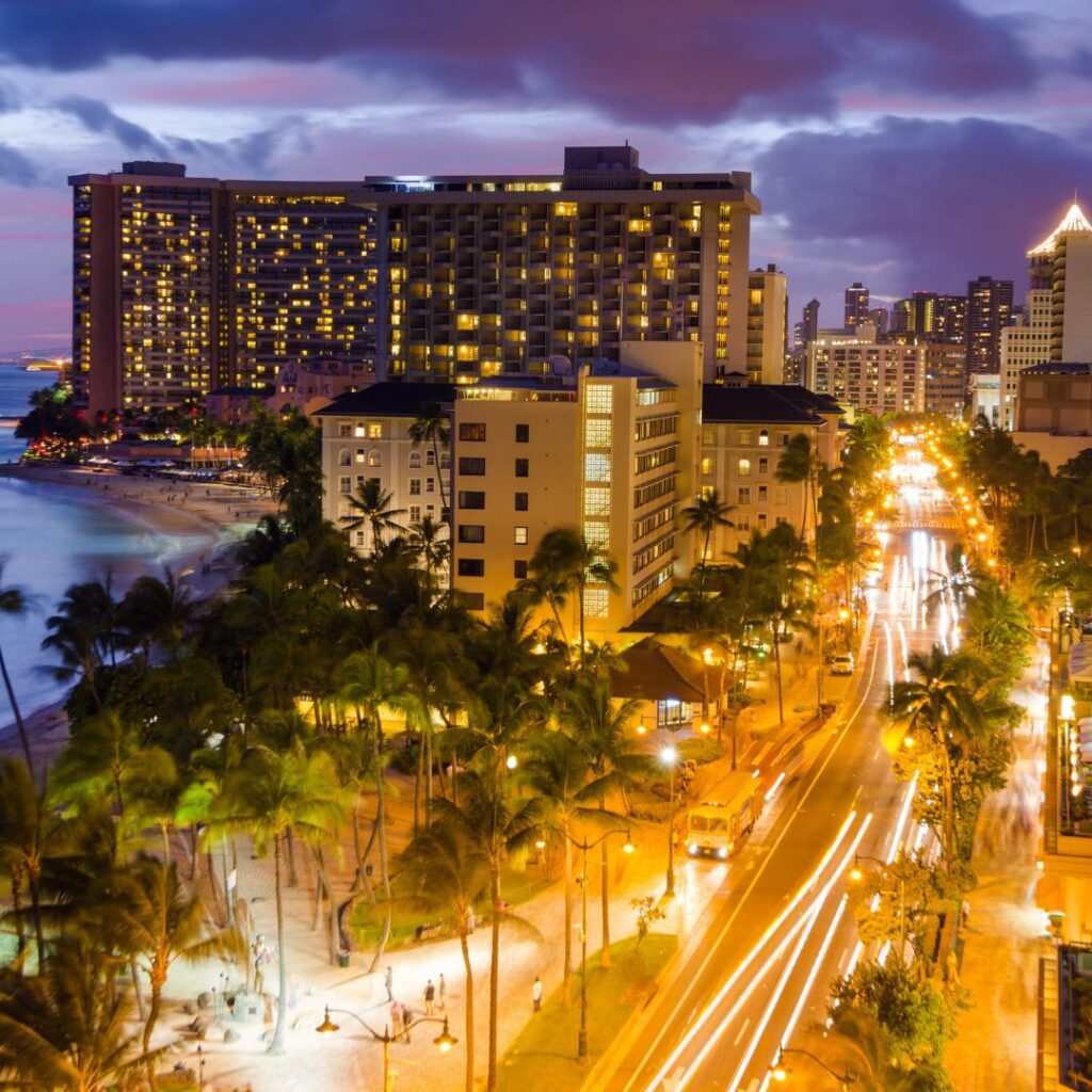 The 23 Best Things To Do In Waikiki |A Local Guide (2025) Hawaii Calling a city with palm trees and buildings on the beach