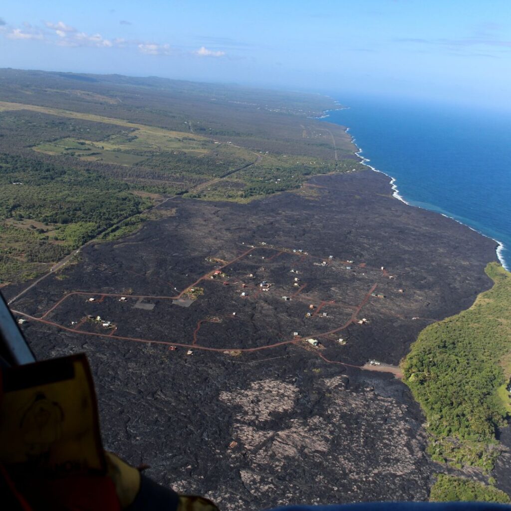 The 49 Best Things To Do In Kona Hawaii Calling an aerial view of a landscape with a body of water and a blue sky