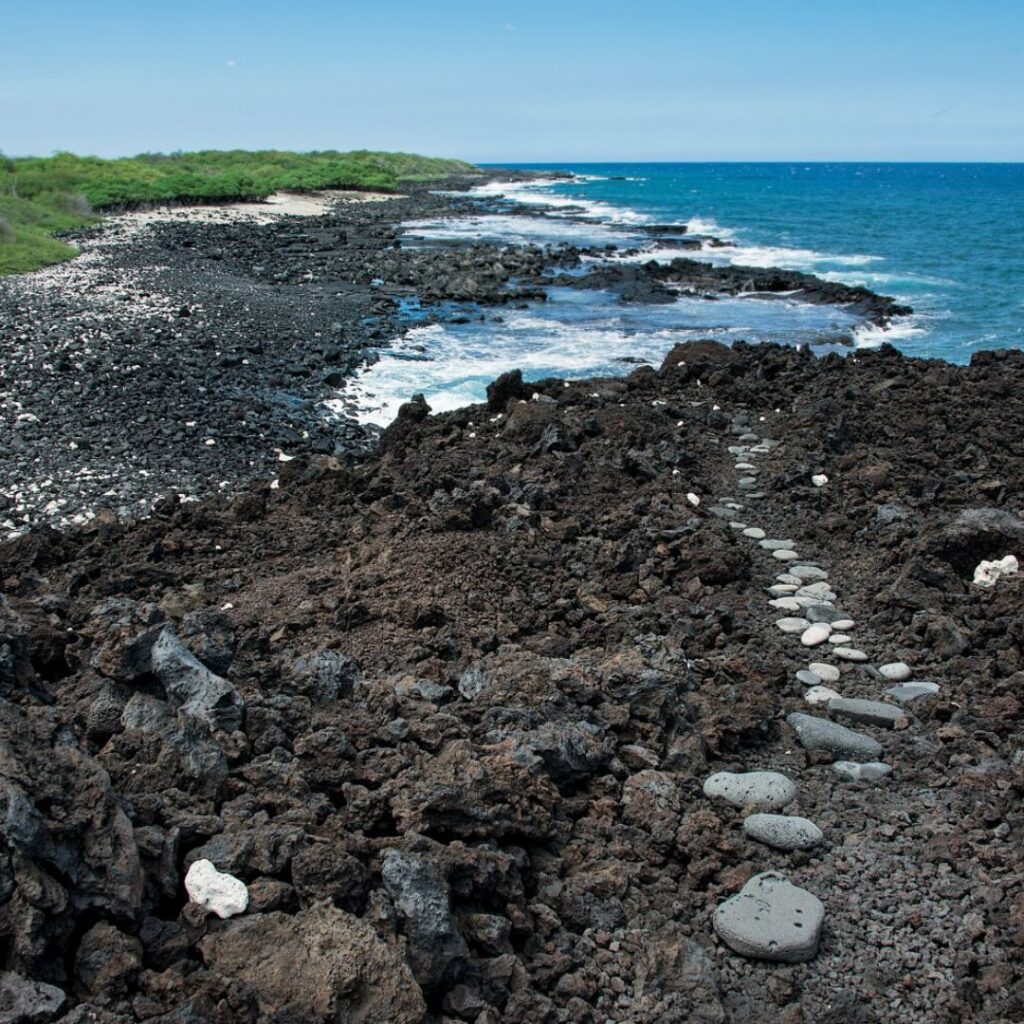 The 49 Best Things To Do In Kona Hawaii Calling a rocky beach with a path leading to the ocean