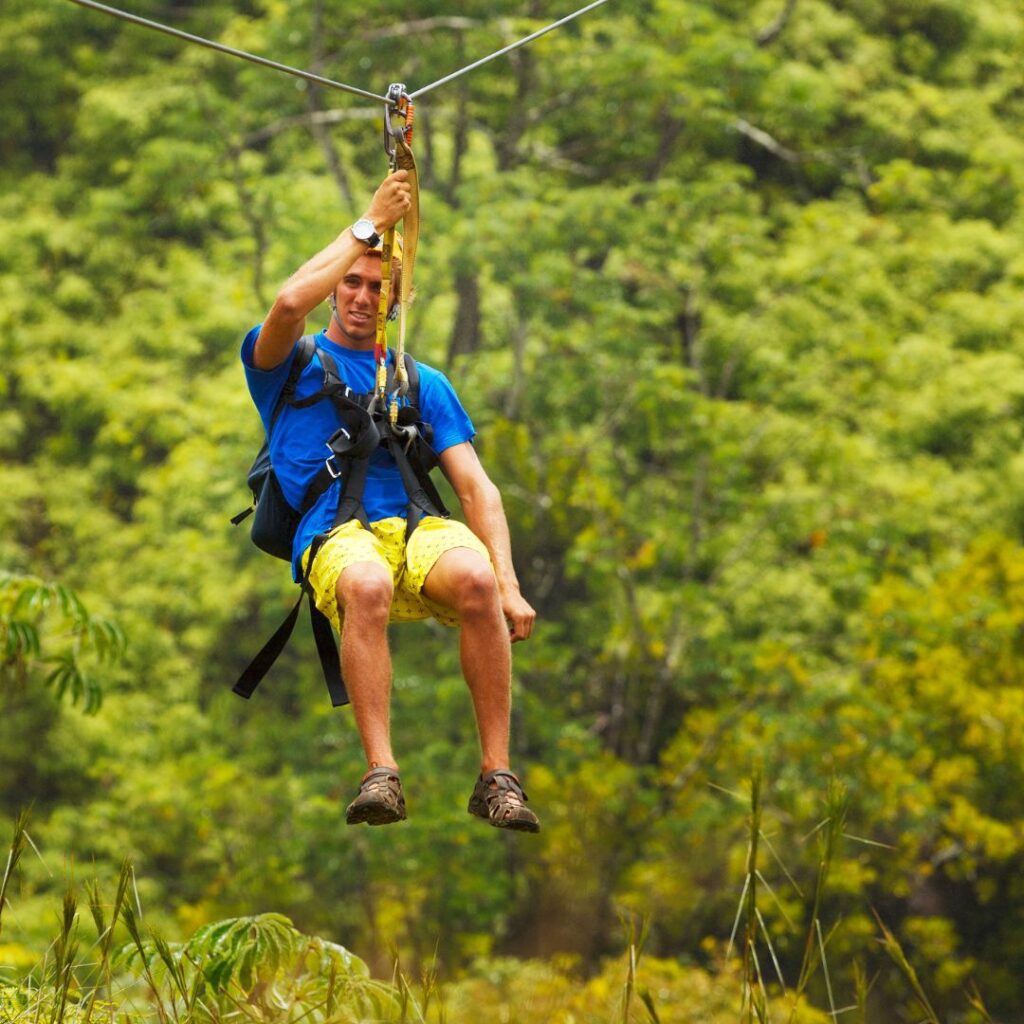 The 26 Best Things To Do On Maui | Bucket List Guide (2025) Hawaii Calling a man in a blue shirt and yellow shorts on a zip line