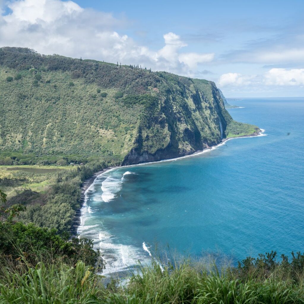 35 Best Things To Do On The Big Island Hawaii Calling a body of water with a cliff and trees with Waipio Valley in the background