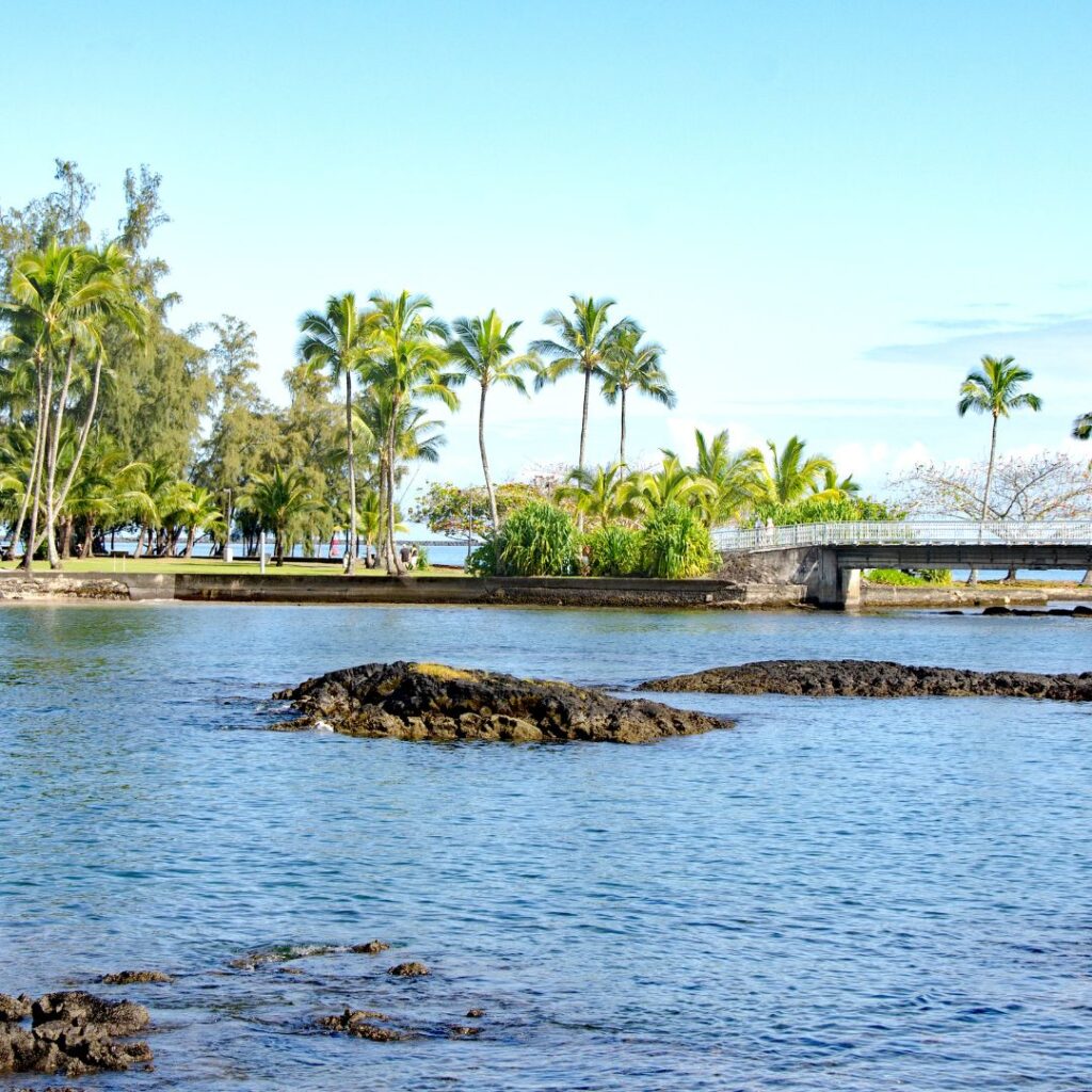 35 Best Things To Do On The Big Island Hawaii Calling a body of water with trees and a bridge