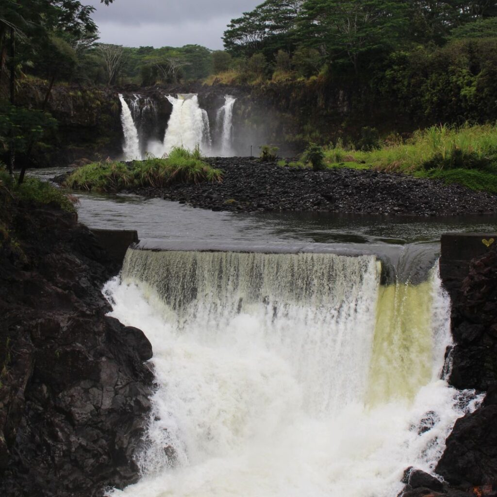 35 Best Things To Do On The Big Island Hawaii Calling a waterfall with a river and trees
