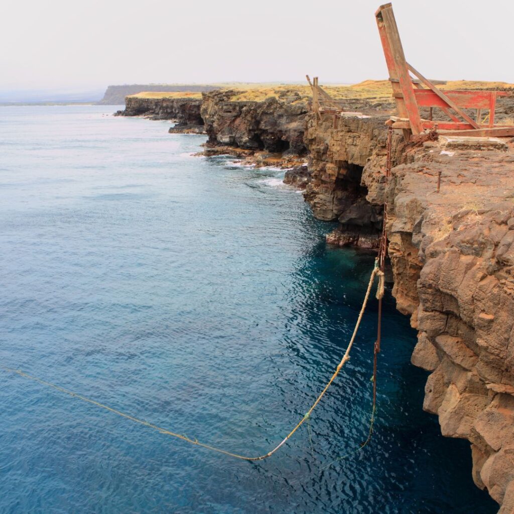 35 Best Things To Do On The Big Island Hawaii Calling a rope tied to a cliff