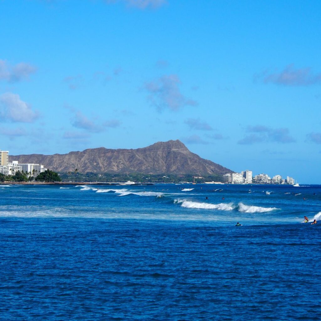 15 Best Snorkel Tours On Oahu | Book These Early Hawaii Calling a body of water with buildings and mountains in the background with Diamond Head in the background