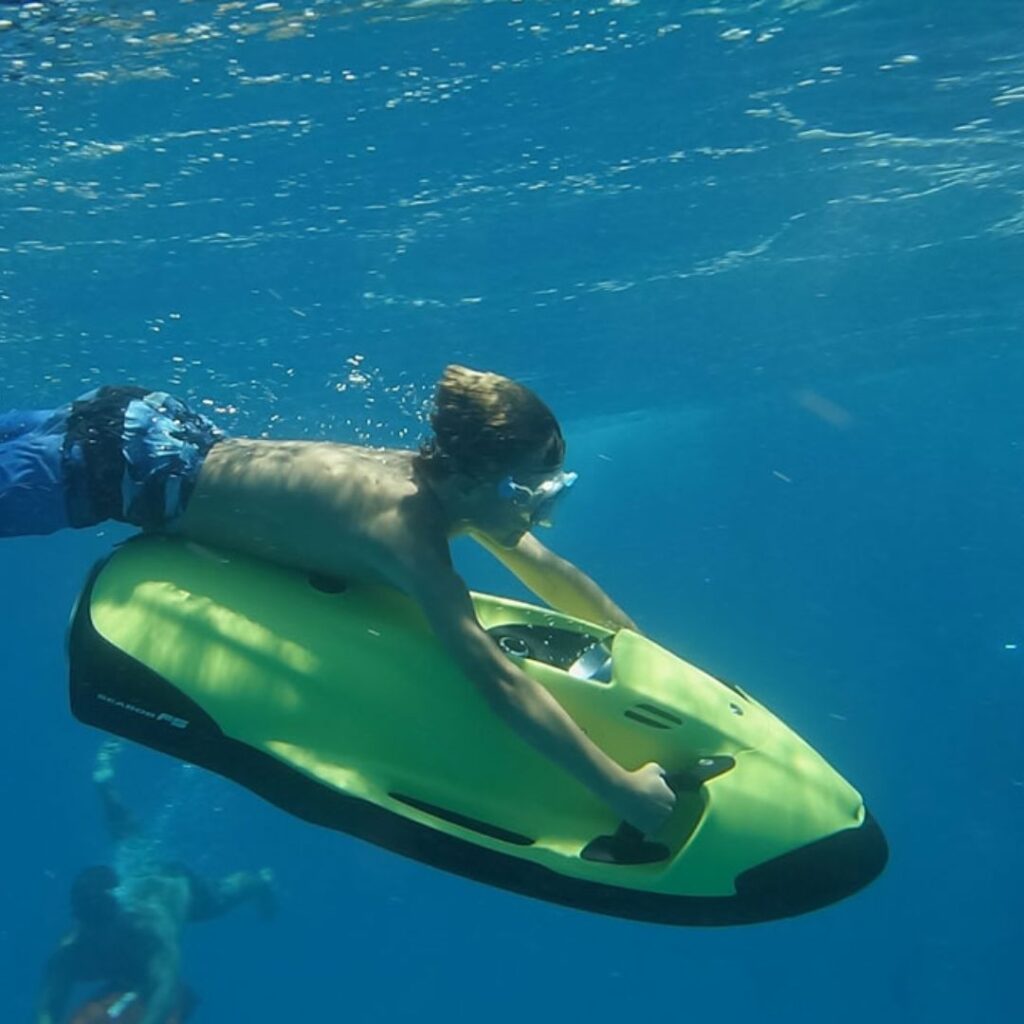 15 Best Snorkel Tours On Oahu | Book These Early Hawaii Calling a boy on a jet ski in the water