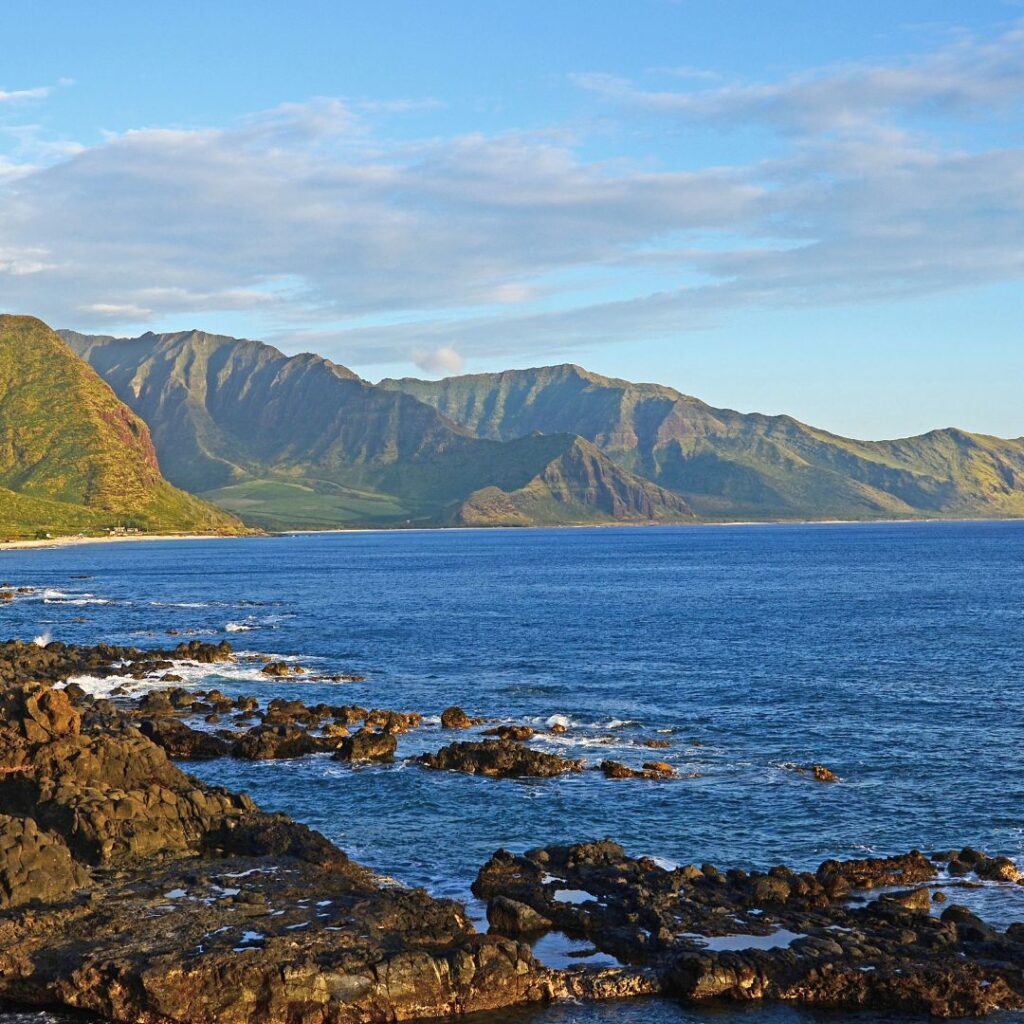 15 Best Snorkel Tours On Oahu | Book These Early Hawaii Calling a rocky shore with mountains in the background