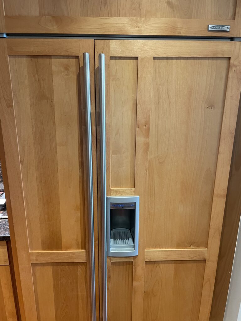 Review Montage Kapalua Bay | Maui Luxury Hawaii Calling a wooden cabinet with a silver handle and a ice maker