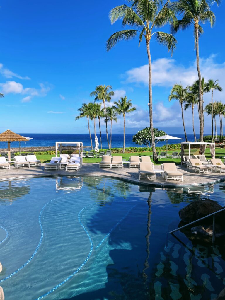 Review Montage Kapalua Bay | Maui Luxury Hawaii Calling a pool with lounge chairs and palm trees