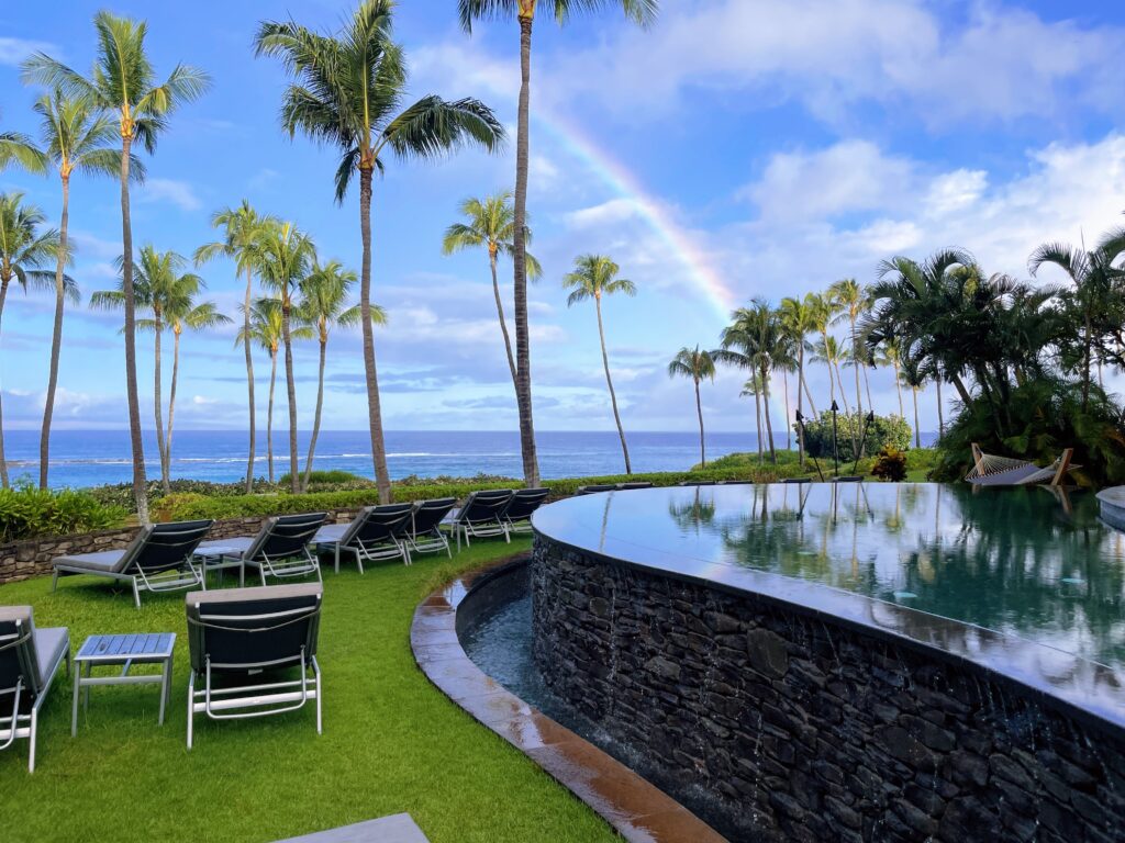 Review Montage Kapalua Bay | Maui Luxury Hawaii Calling a pool with chairs and a pool in the middle of a tropical area