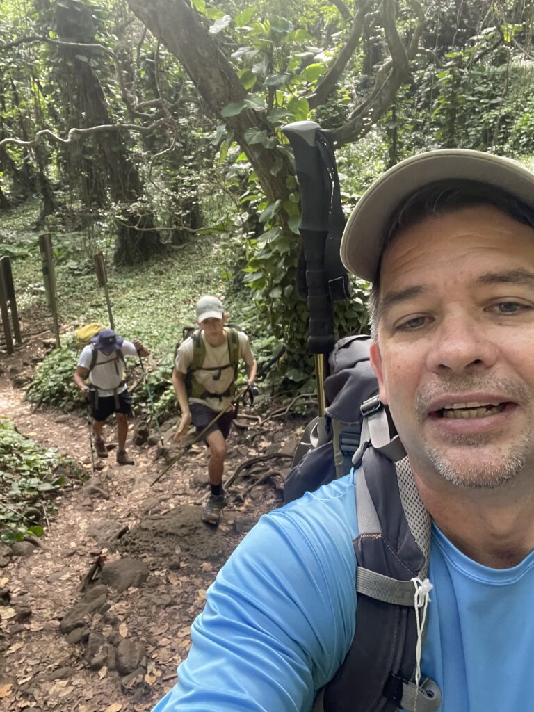 Kalalau Trail Adventure: My Unforgettable Hiking Experience on Kaua'i Hawaii Calling a group of people hiking in the woods