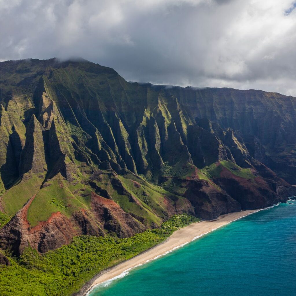 Kalalau Trail Adventure: My Unforgettable Hiking Experience on Kaua'i Hawaii Calling a beach and mountains with clouds