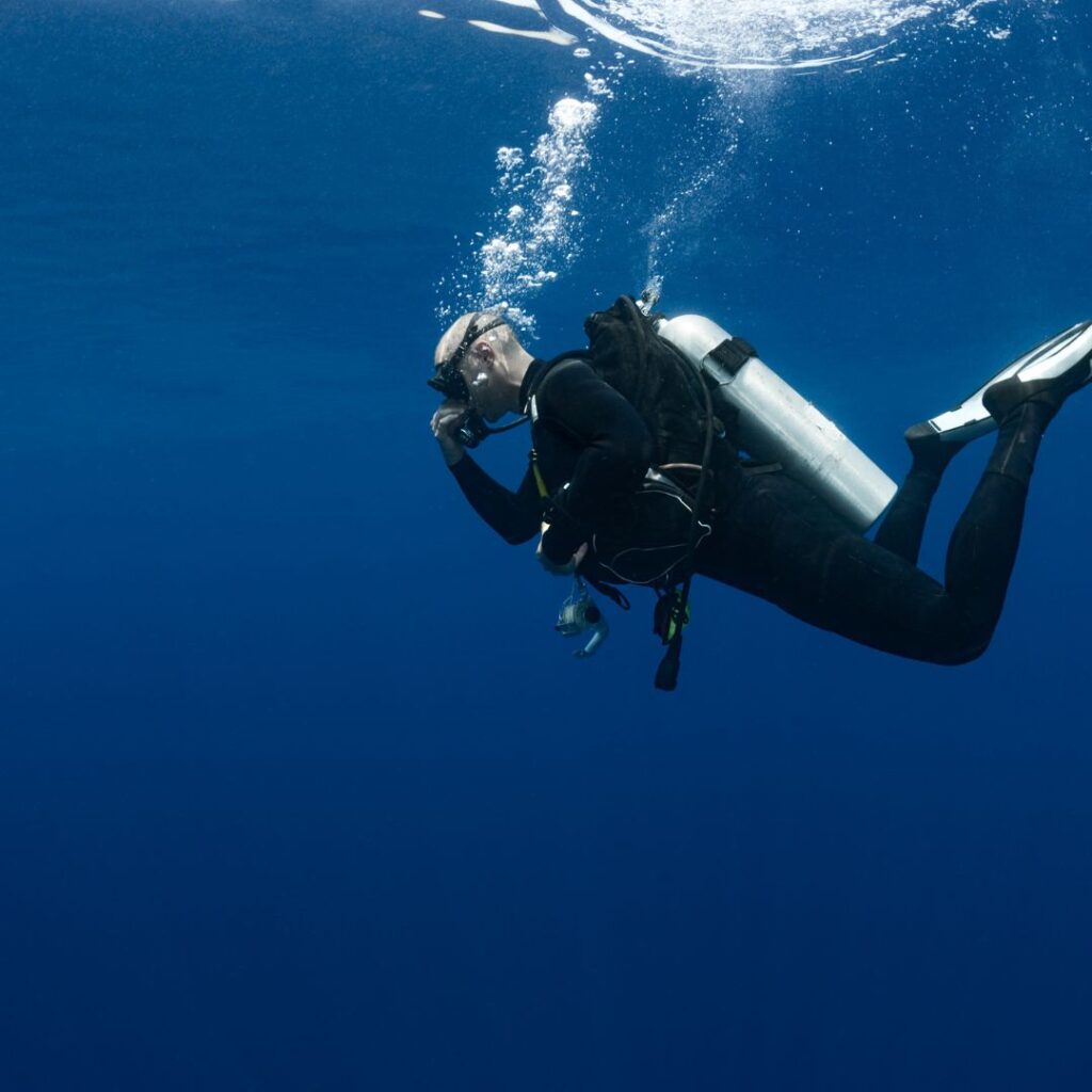 10 Breathtaking Honolulu Water Activities You Have To Experience (2025) Hawaii Calling a person in a scuba suit and goggles underwater