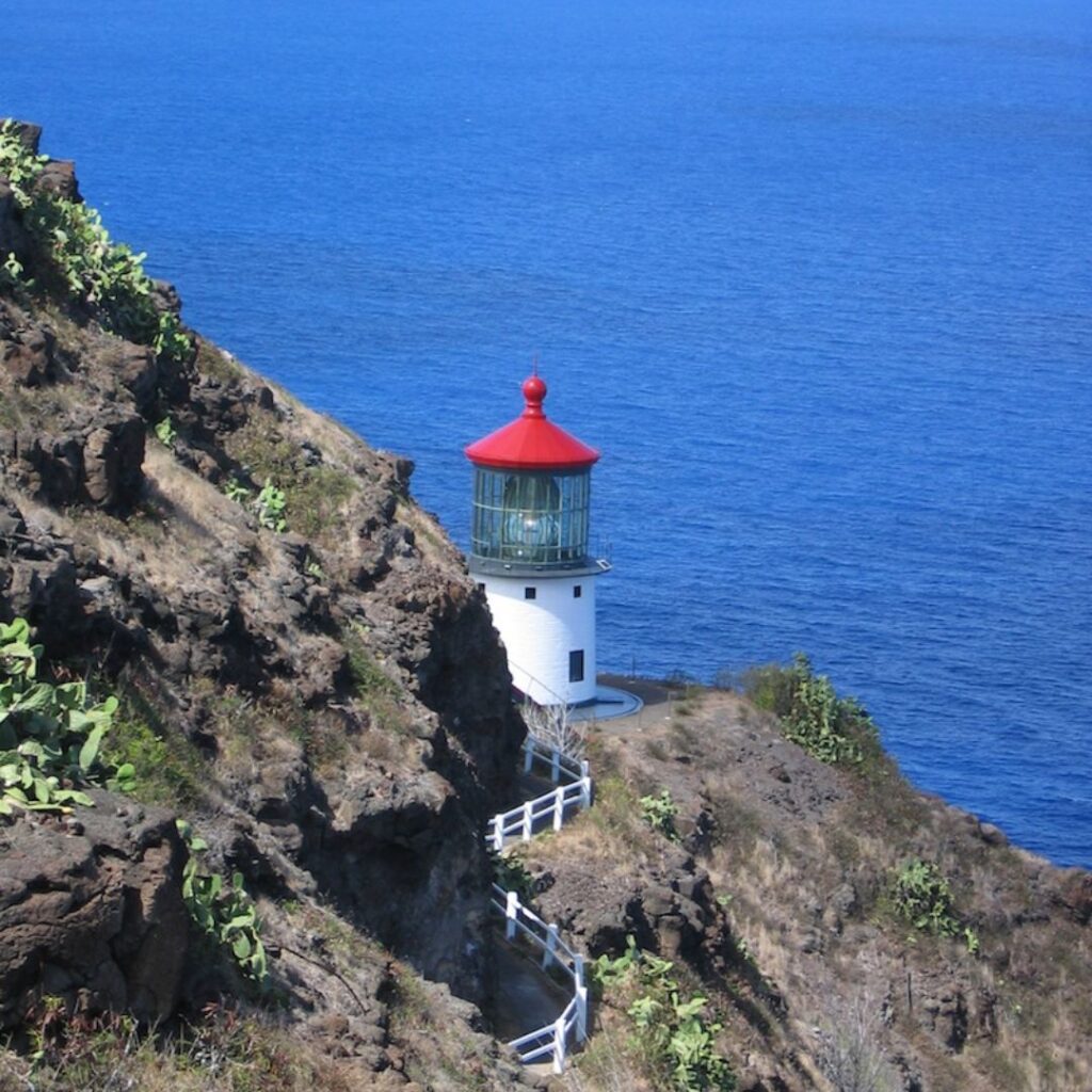 Guide to Volunteering on Oahu: 14 Unforgettable Ways to Give Back Hawaii Calling a lighthouse on a cliff by the ocean