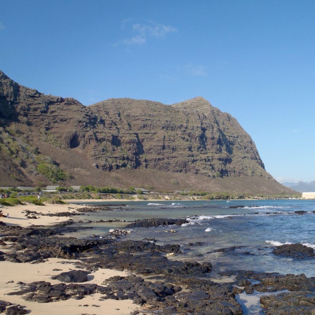 Kaupō Hillside Restoration: How to Get Involved as a Volunteer Hawaii Calling a rocky beach with a mountain in the background