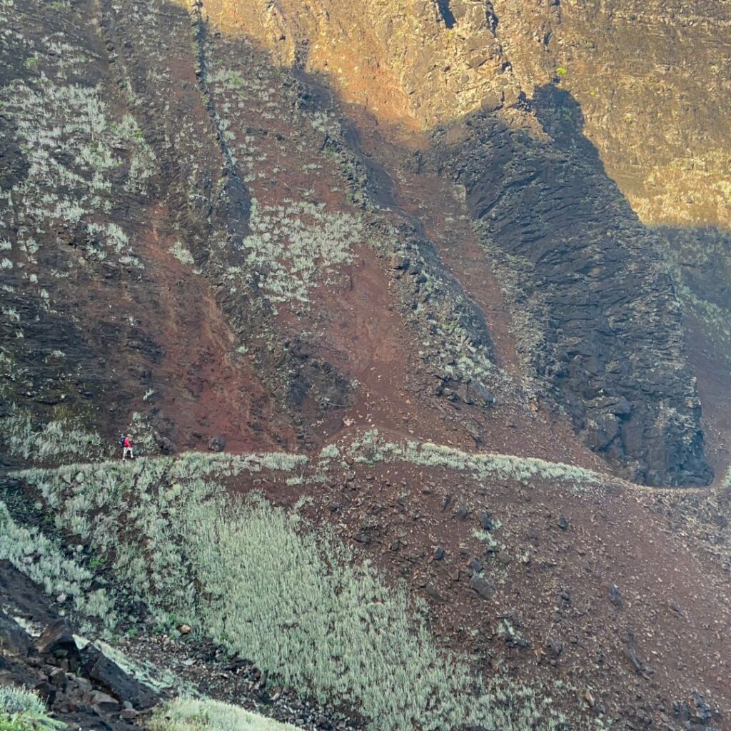 Kalalau Trail Guide: Planning Your Ultimate Hiking Adventure Hawaii Calling a person walking on a rocky mountain