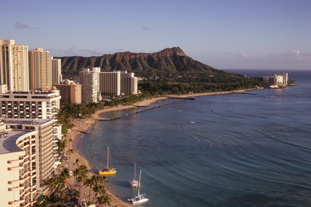 Aloha Heart: A Tale of Love and Conservation in Hawaii Hawaii Calling a beach with boats and buildings in the background with Diamond Head in the background