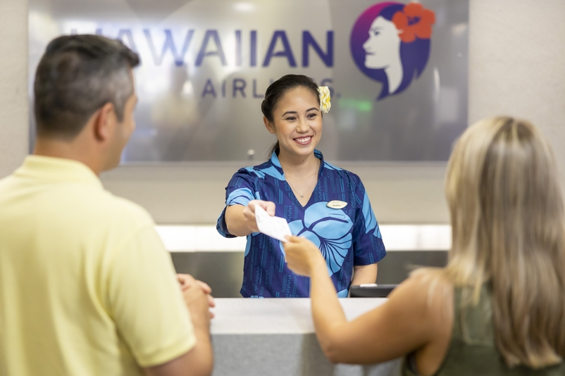 Travel + Leisure Declares Hawaiian Airlines as the Top U.S. Airline 2023 Hawaii Calling a woman handing a card to a man