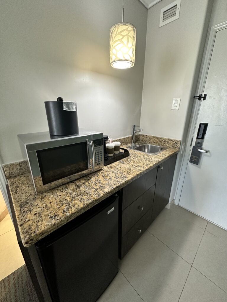 Courtyard by Marriott Waikiki Beach Review | Perfectly Positioned Hawaii Calling a kitchen with a sink and microwave