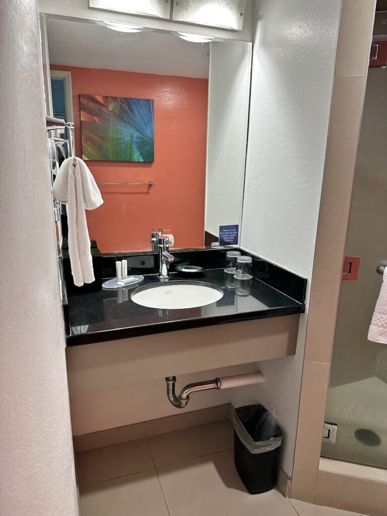 Courtyard by Marriott Waikiki Beach Review | Perfectly Positioned Hawaii Calling a bathroom with a mirror and sink