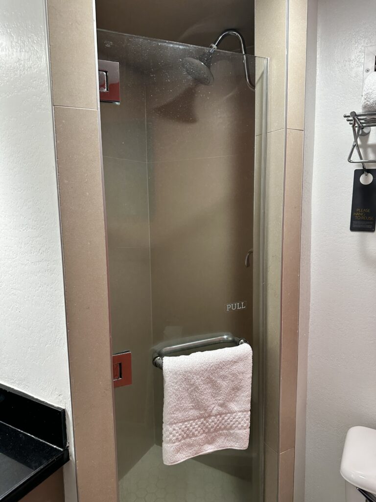 Courtyard by Marriott Waikiki Beach Review | Perfectly Positioned Hawaii Calling a shower with a towel on the door