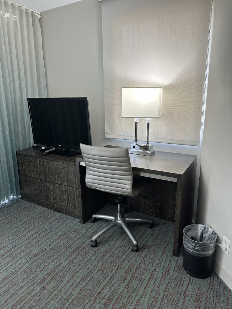 Courtyard by Marriott Waikiki Beach Review | Perfectly Positioned Hawaii Calling a desk with a lamp and a television