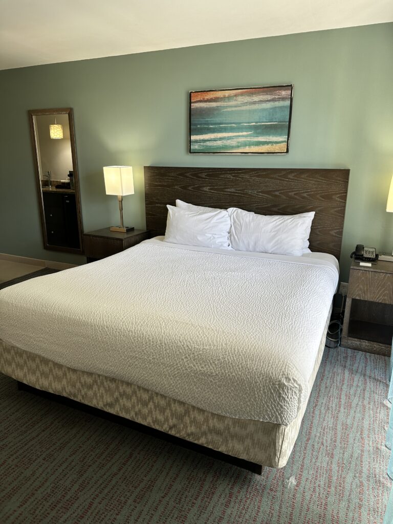 Courtyard by Marriott Waikiki Beach Review | Perfectly Positioned Hawaii Calling a bed with white sheets and lamps