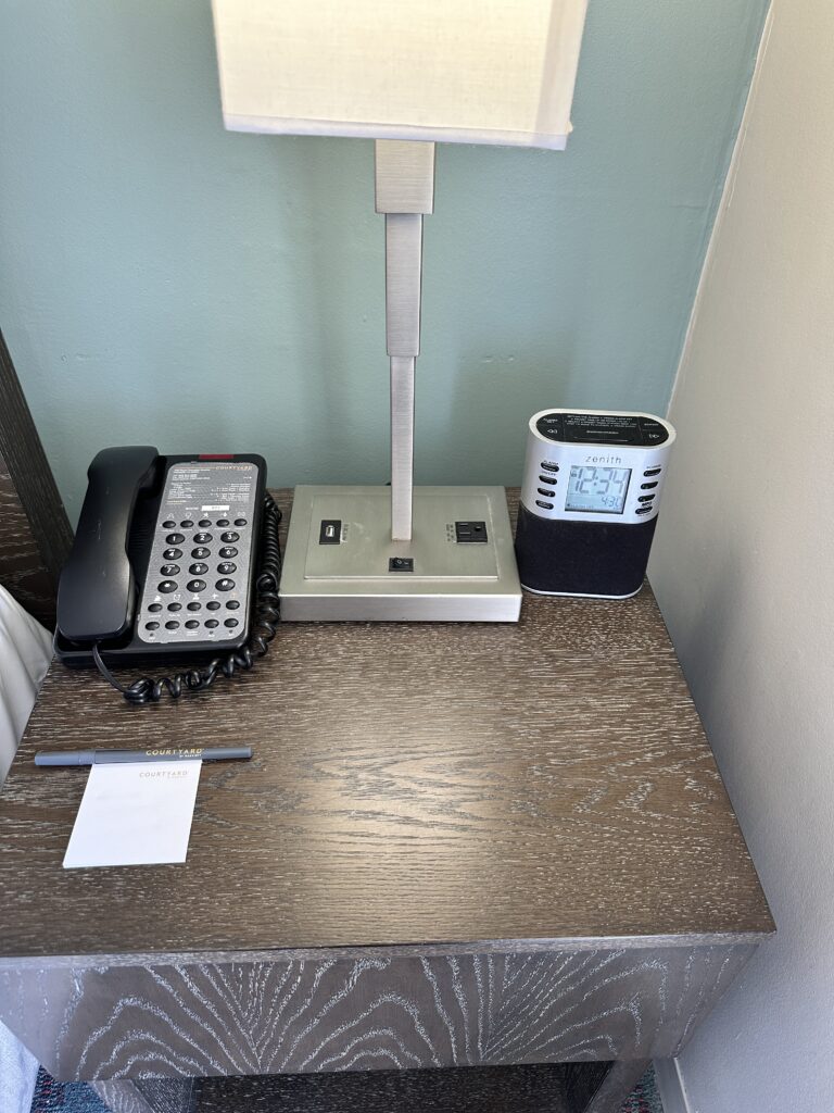 Courtyard by Marriott Waikiki Beach Review | Perfectly Positioned Hawaii Calling a desk with a telephone and a phone on it