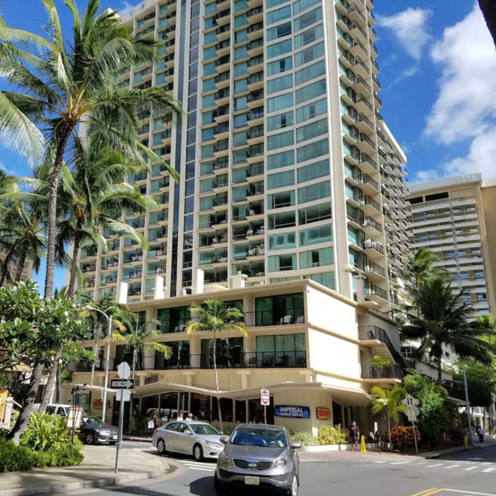 20 Best Budget Hotels On Oahu (2025) Comfort and Convenience for Every Wallet Hawaii Calling a tall building with palm trees and cars on the street