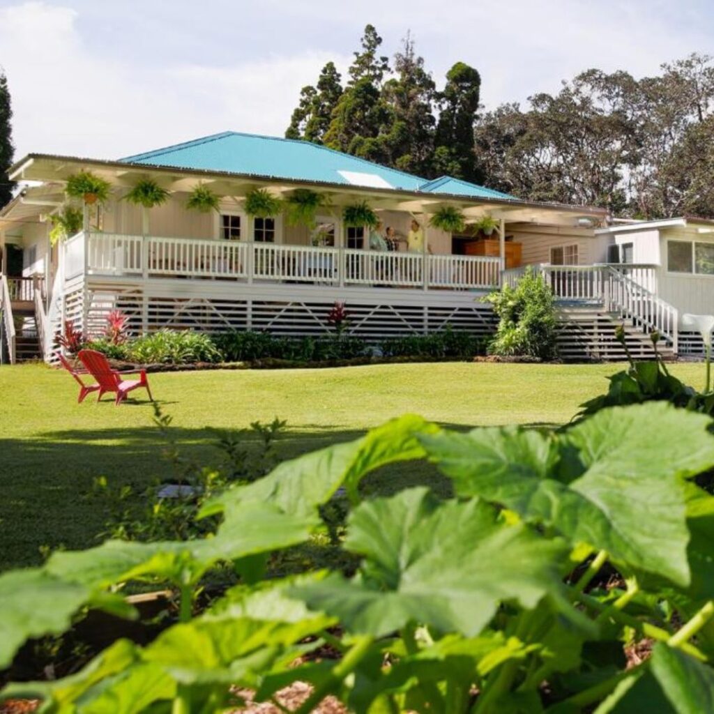 a house with a lawn and lawn chairs