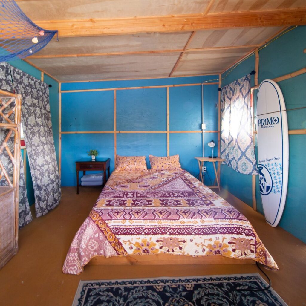 a room with a bed and a surfboard
