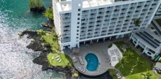 The 18 Best Budget Hotels on the Big Island That Won’t Break the Bank a hotel with a pool and a body of water