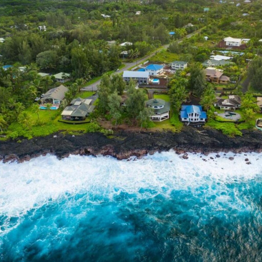 a aerial view of a beach with houses and trees
