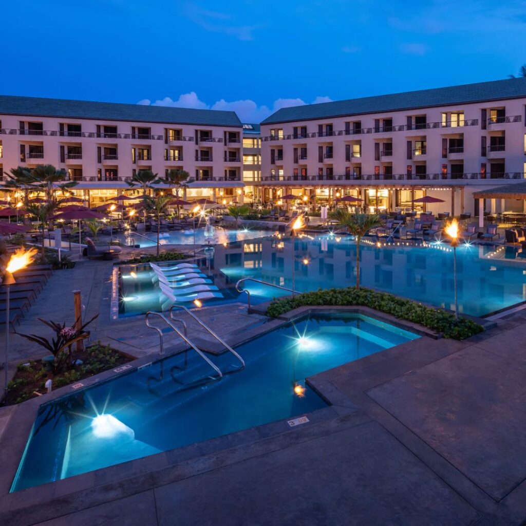 15 Top-Rated Budget Hotels On Kaua'i: Affordable Luxury Hawaii Calling a swimming pool and a building with fire in the background
