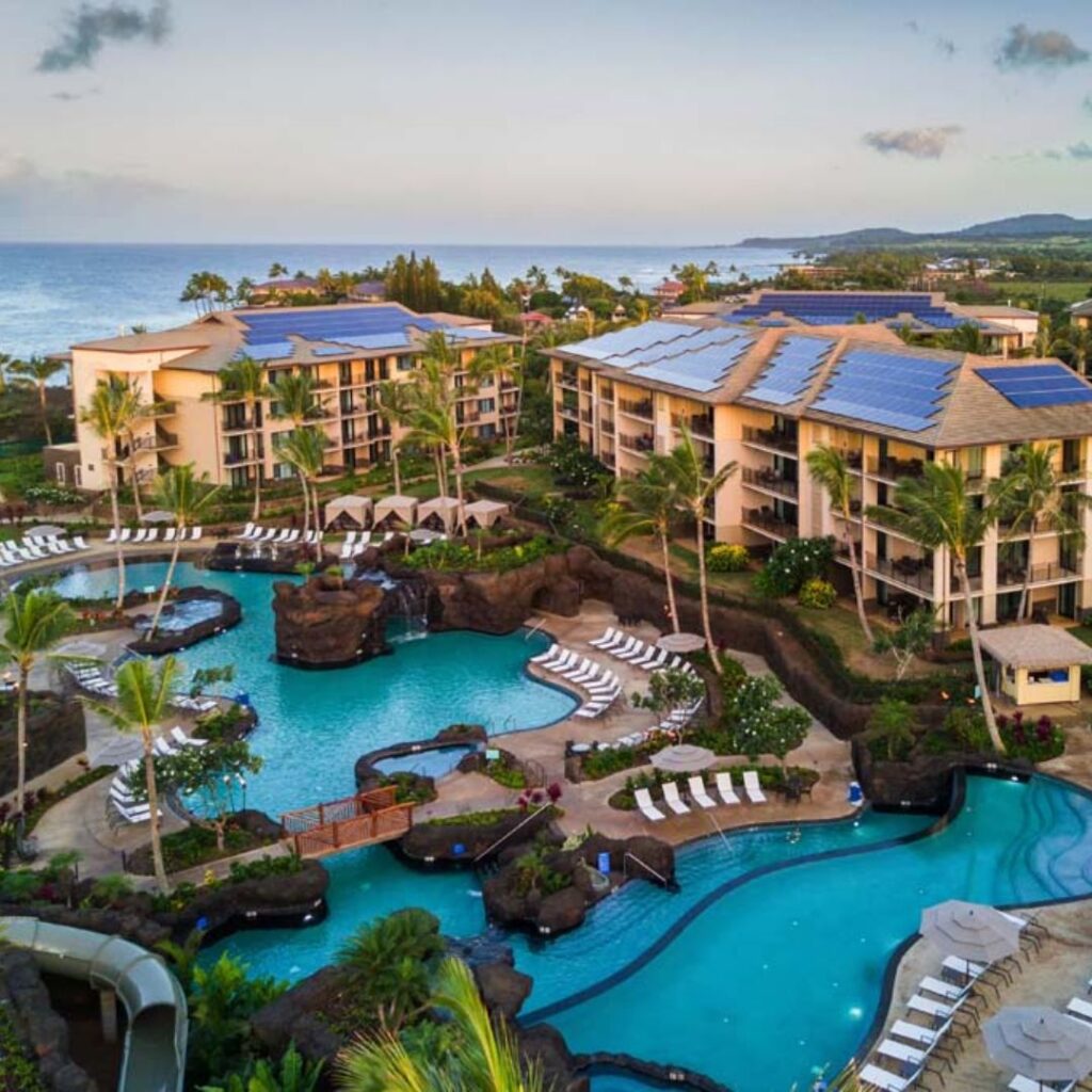 12 Best Family Hotels On Kaua'i for a Dream Hawaiian Vacation Hawaii Calling a swimming pool with a large pool and a building with a body of water