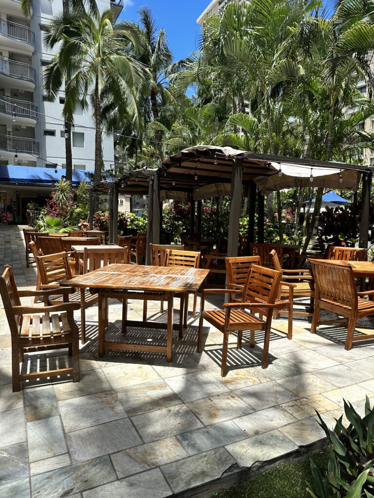 Kalo Hawaiian Food by Chai's | Unique Flavors In Waikiki Hawaii Calling a table and chairs on a patio