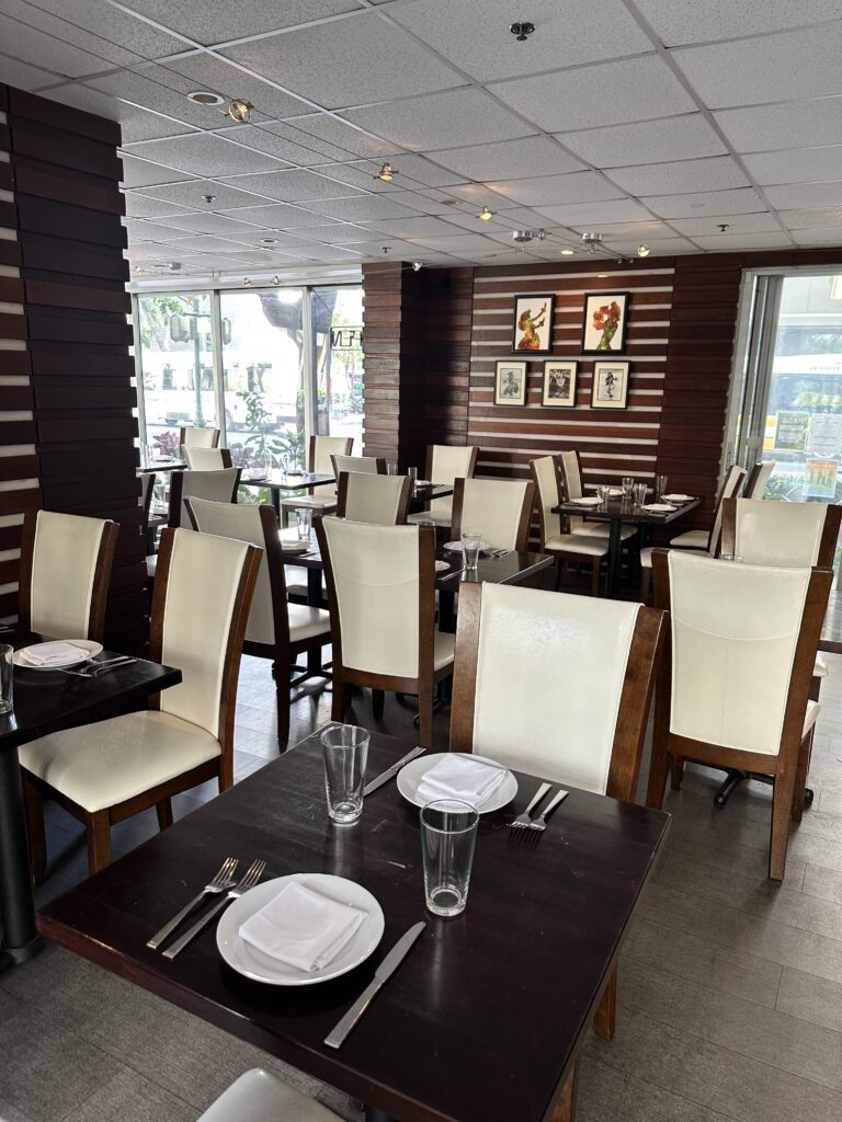 Kalo Hawaiian Food by Chai's | Unique Flavors In Waikiki Hawaii Calling a room with tables and chairs