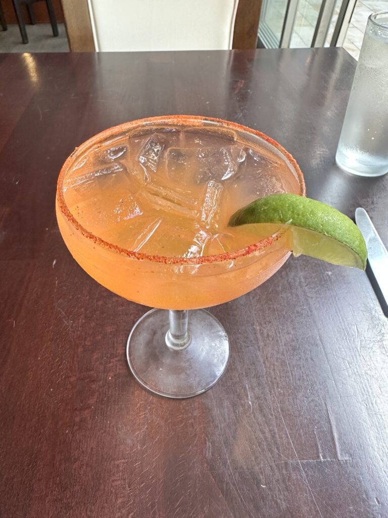 Kalo Hawaiian Food by Chai's | Unique Flavors In Waikiki Hawaii Calling a glass with a drink and a lime wedge
