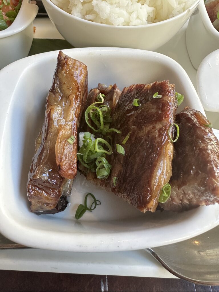 Kalo Hawaiian Food by Chai's | Unique Flavors In Waikiki Hawaii Calling a plate of meat with green onions