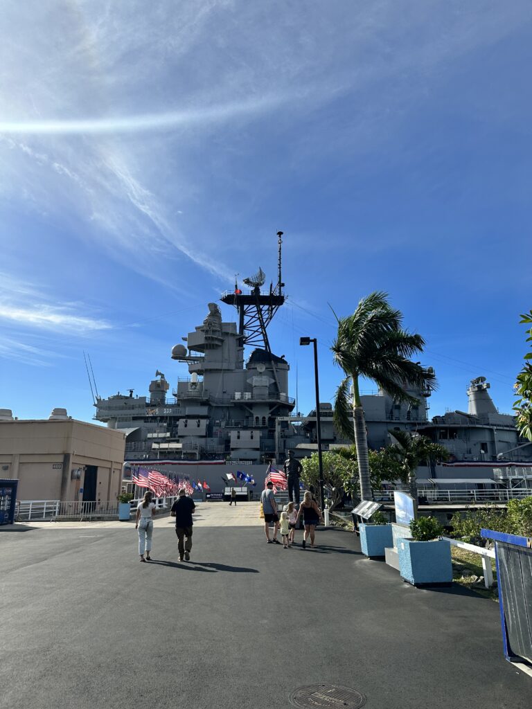 Volunteering At The Battleship Missouri Memorial | Amazing History Behind The Scenes Hawaii Calling people walking on a road near a large ship