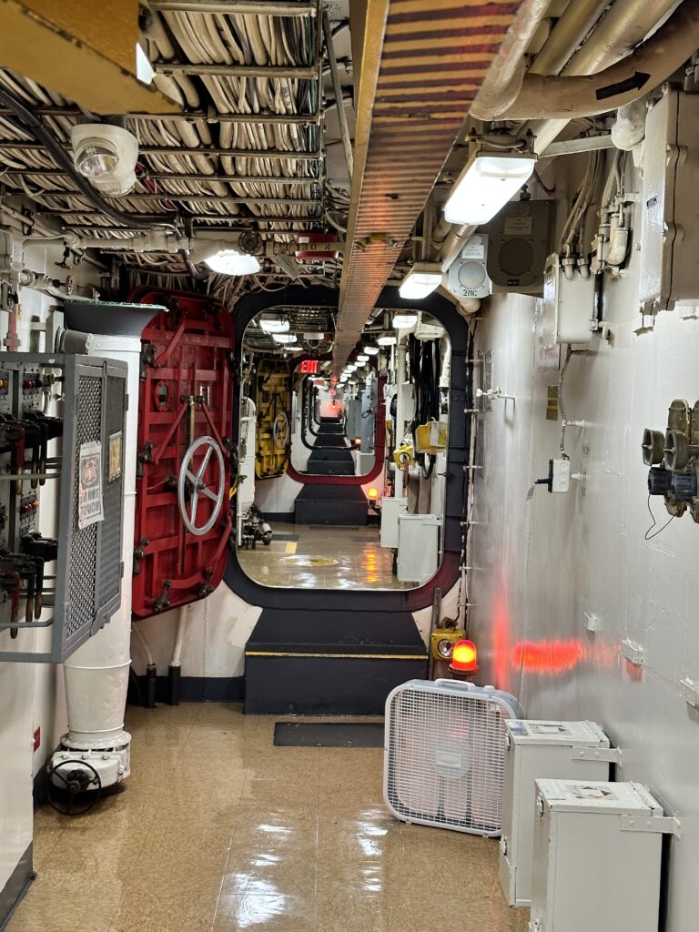 Volunteering At The Battleship Missouri Memorial | Amazing History Behind The Scenes Hawaii Calling a hallway with a door and pipes
