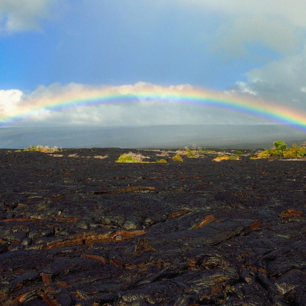 What's the Best Island to Visit in Hawaii in December (2025)? Hawaii Calling a rainbow over a lava field