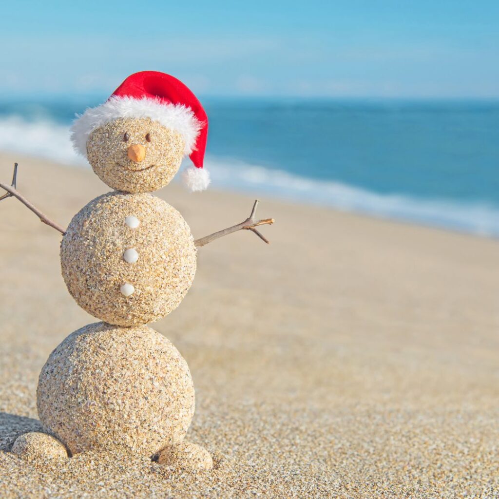 What's the Best Island to Visit in Hawaii in December (2025)? Hawaii Calling a snowman made of sand with a santa hat on the beach
